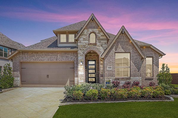 Front exterior of the Southlake model home with brick and stone elevation at Creekview Meadows.