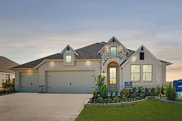 Exterior of the Rockwall floor plan model home with brick and stone elevation at Clearview Ranch in Royse City, TX.