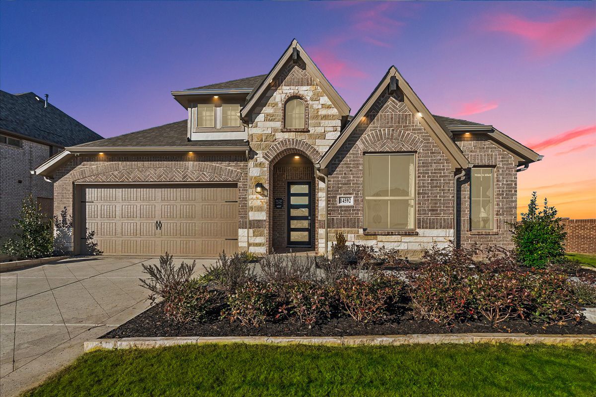 Front exterior of the Southlake model home with brick and stone elevation at Creekview Meadows.