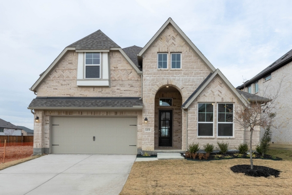 Grapevine II floor plan exterior featuring a two-story brick home with arched entry and two-car garage at 14530 Jemison Street in Pilot Point, TX, Celina ISD.