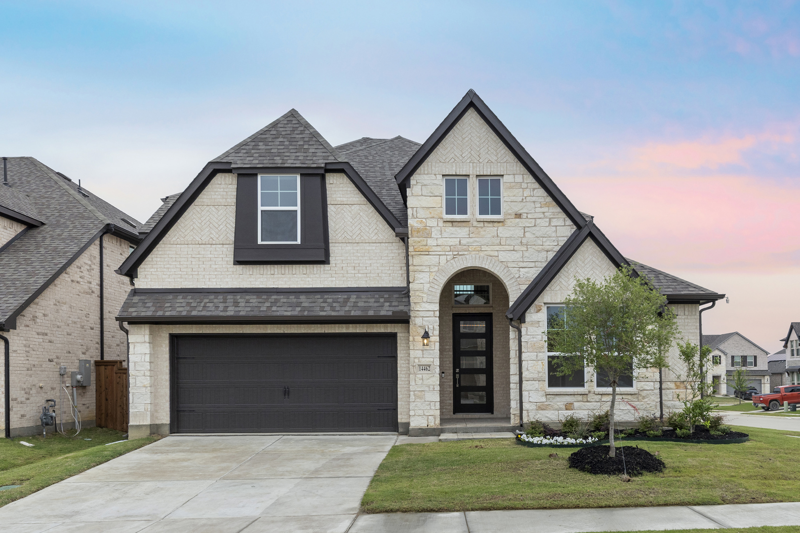 Exterior image of two story white brick home for sale.