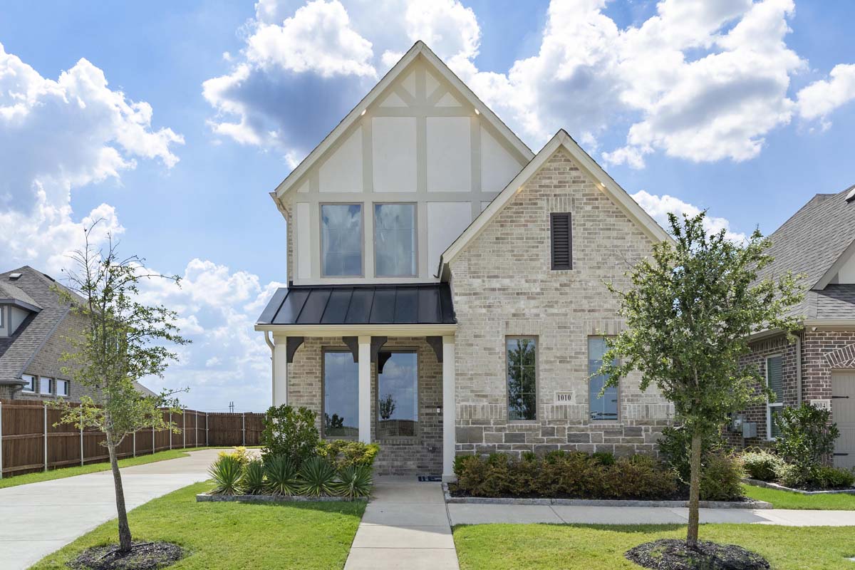 Beautiful model home for sale at 1010 Joy Mill Place in Elevon, Lavon, Texas featuring attractive curb appeal, landscaped front yard, covered entry, and modern exterior design.